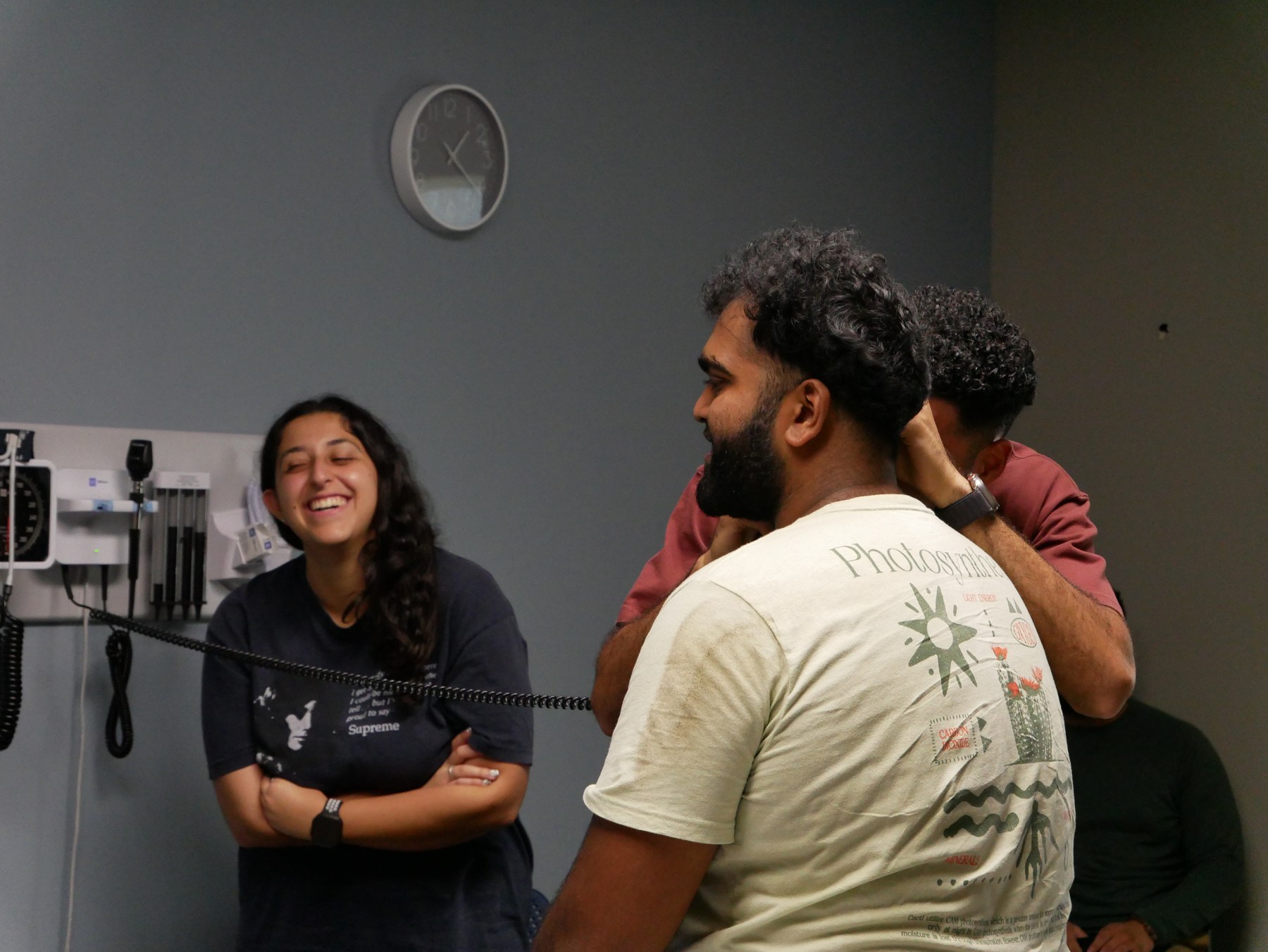 ACSOM students talking together in a clinical skills classroom