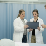 Student and mentor holding checking reports in a clinical simulation lab