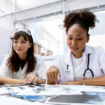 Female medical student study in class room. medical students studying human brain disease diagnosis through learning from X-ray film. Learn about brain surgery for diagnosis.
